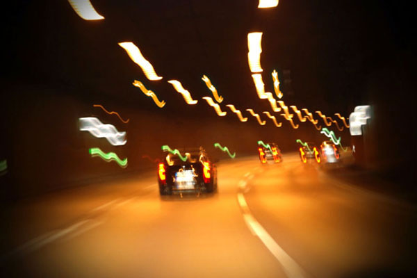 Blurry scene of car driving through tunnel 