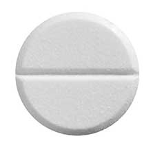Primer plano de una pastilla blanca (opioide recetado)