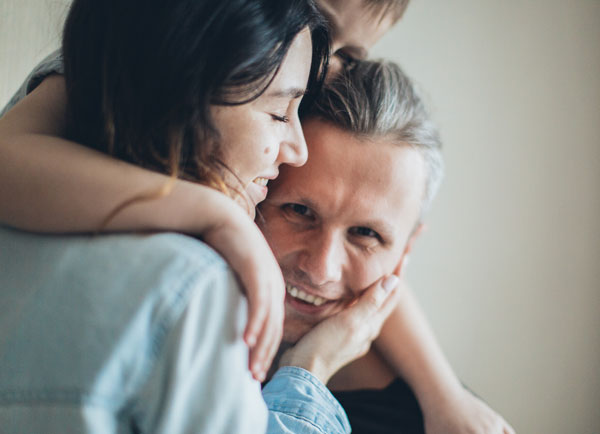 Man being hugged by his family