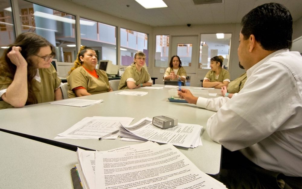 Uniformed women in a jail participate in a drug treatment seminar in Santa Ana, CA.