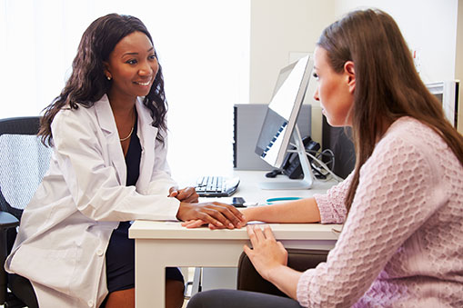 A female doctor talking to a female patient
