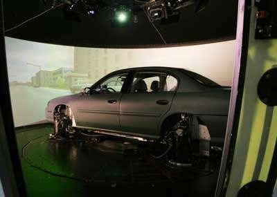 Photo of car set up with screens surrounding it to be used as a simulator