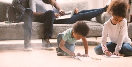 Two children coloring pictures