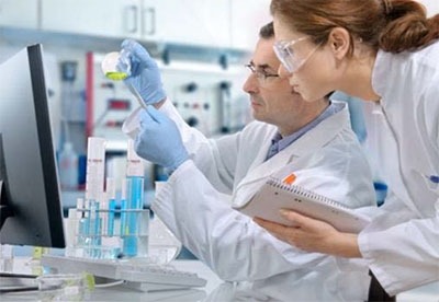 Photo of a female and male scientist conducting research.