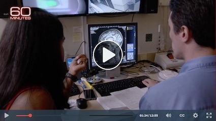 Image of researchers looking at a brain scan on a computer