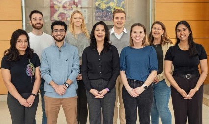 Dr. Carrie Ferrario (center) with lab members.