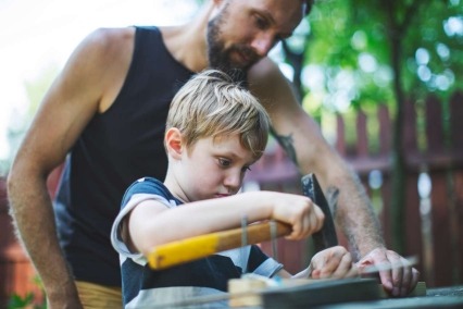 Un padre y su pequeño hijo trabajando juntos. 