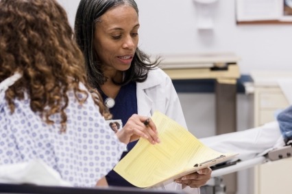 Doctor discussing care with a patient in the emergency room.