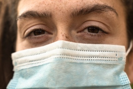 Close-up of woman wearing an M95 face mask.