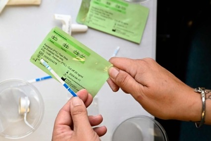 Close-up of hands holding a fentanyl test strip.