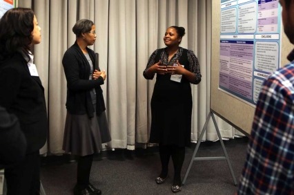 Group of people in front of a poster presentation