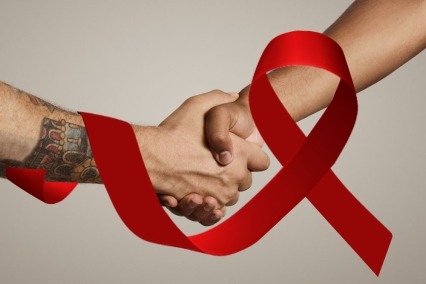 Hands shaking behind a red AIDS ribbon