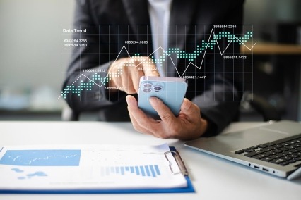 Closeup of smartphone user planning with a futuristic dashboard UI, featuring data visualization, calendar interface, and real people.