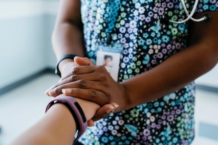 Close-up of practitioner comforting woman in a medical setting