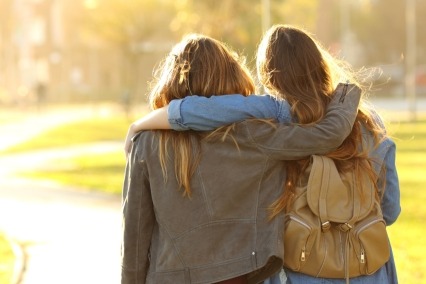 Two young women walking together.