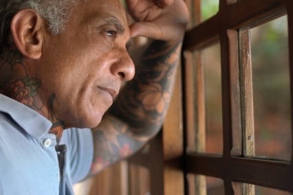 Close-up of a man looking out of a window