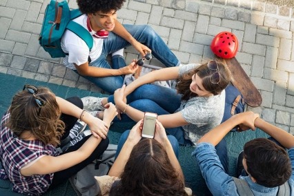 Multiethnic friends laughing and talking after school lesson