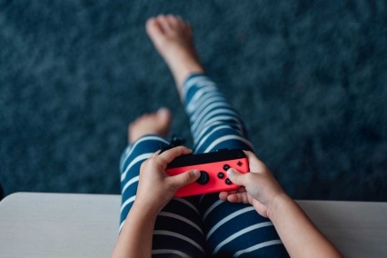 Close-up of young child holding a video game controller.