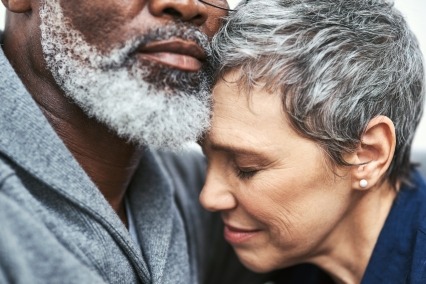 Close-up of a man and woman affectionately embracing.