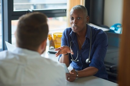 Medical practitioner consulting a patient