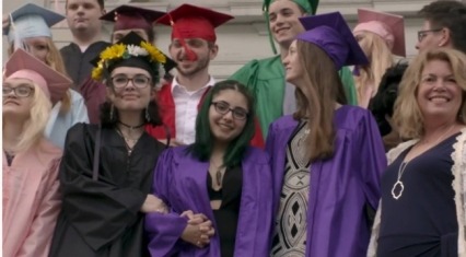 Students gather at graduation with Michelle