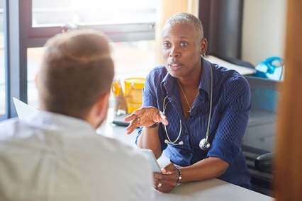Physician discussing prescription with patient.