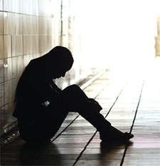 Person sitting alone in a hallway