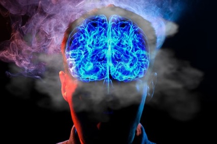 A blue lit up brain with smoke around it.