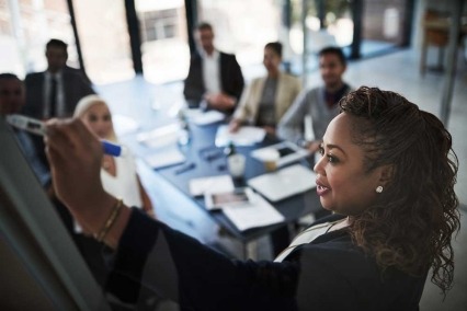 Woman giving presentation to colleagues