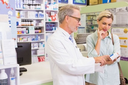 A male pharmacist talking to a woman