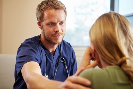 A male nurse practitioner talking to a patient