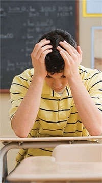 Student with hands on his head
