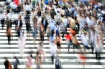 Crowd of pedestrians walking up stairs.