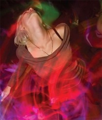Girl dancing in light swirls