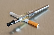 e-cigarette crossed over a cigarette