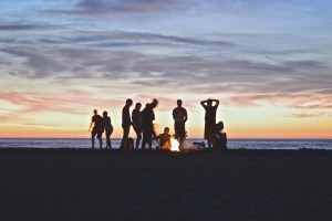 Kids around a beach bonfire