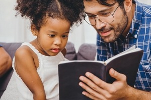Man and child looking at a book