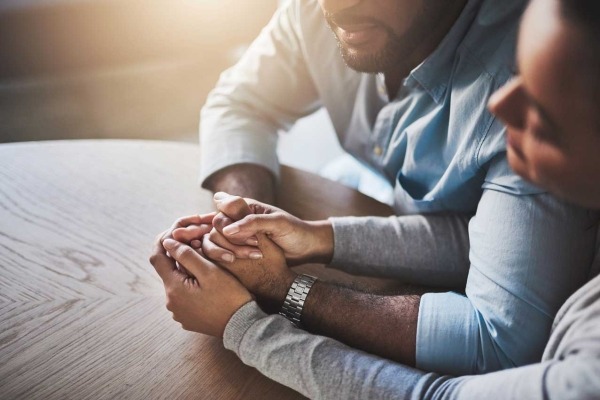 Man and woman holding hands.