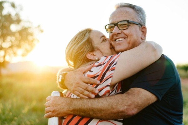 Father embracing adult daughter.