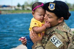 Active duty mother holding child