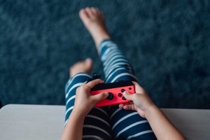 Close-up of young child holding a video game controller.