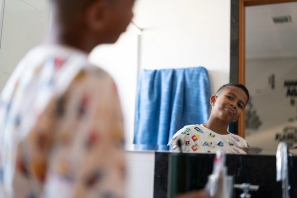 Boy confidently looking in a mirror