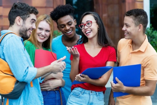 group of teens gathered outside a school