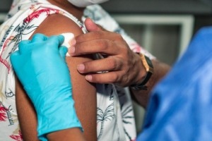 Un hombre recibe un apósito luego de vacunarse contra la COVID