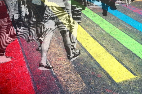 Artistic rendering of people walking across a rainbow colored crosswalk at an intersection.