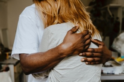 Close-up of adult man and woman embracing