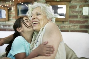 Grandmother smiling with granddaughter.